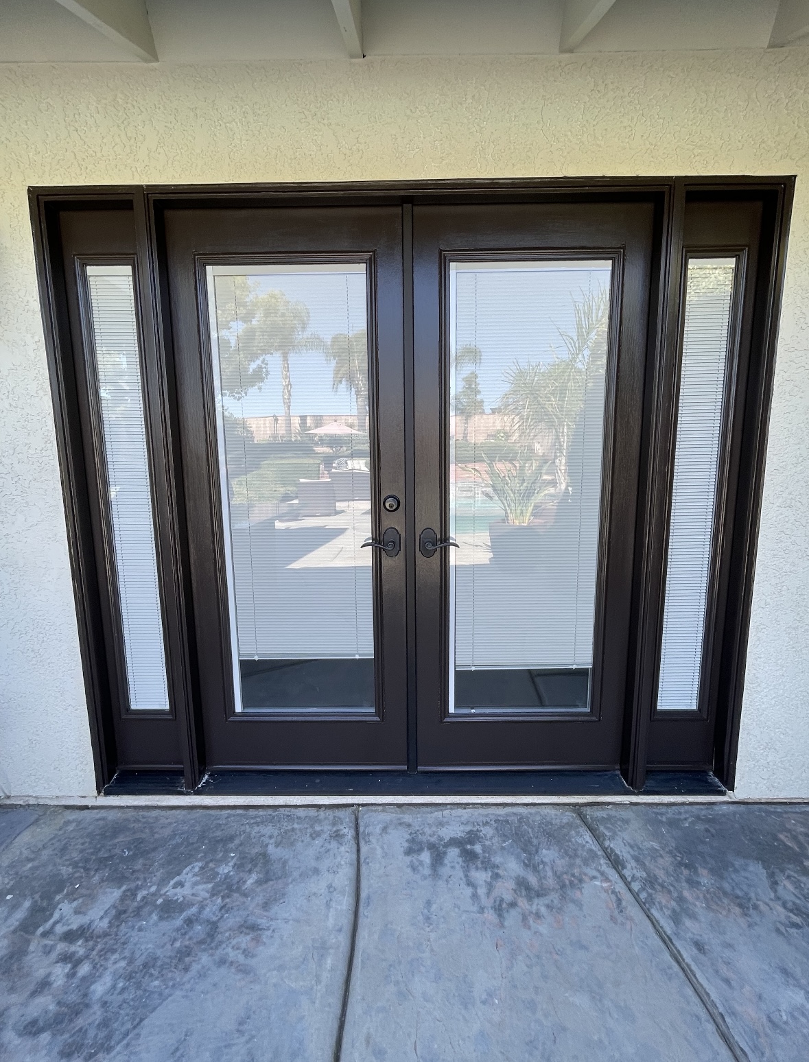 Front double doors refinished in a deep espresso stain